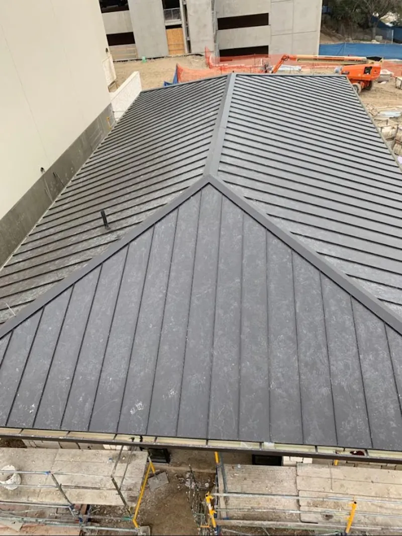 Commercial metal roof construction with crane equipment in Santa Clarita